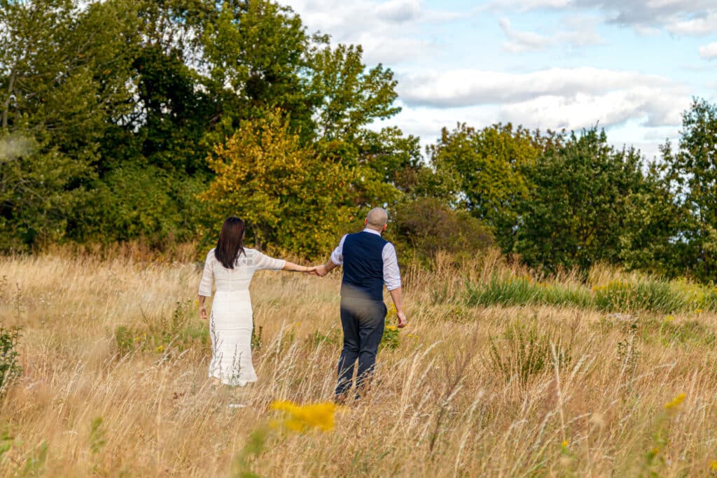 beautiful girl white dress guy field against blue sky with clouds