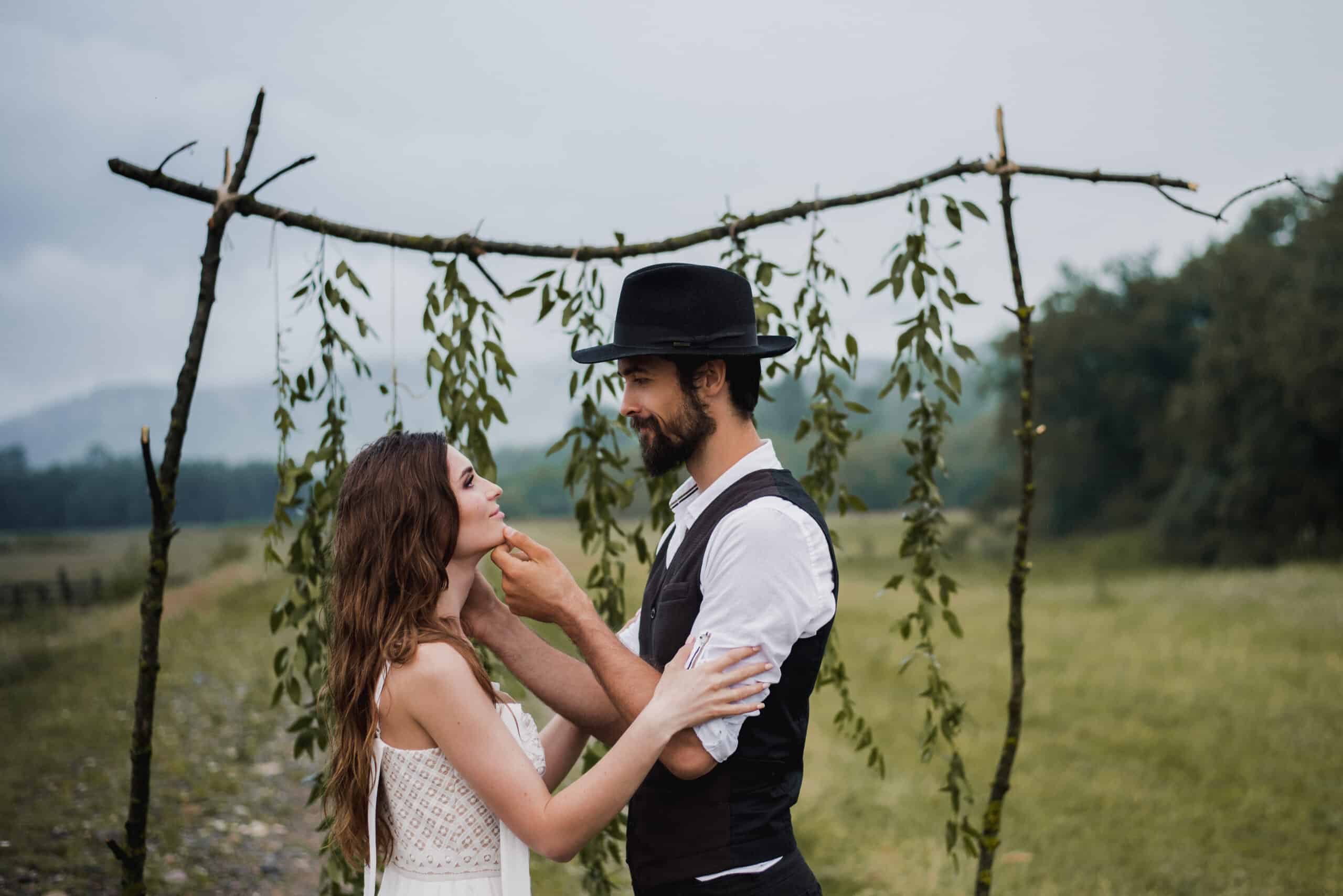 side view romantic couple holding hands while standing field against sky scaled