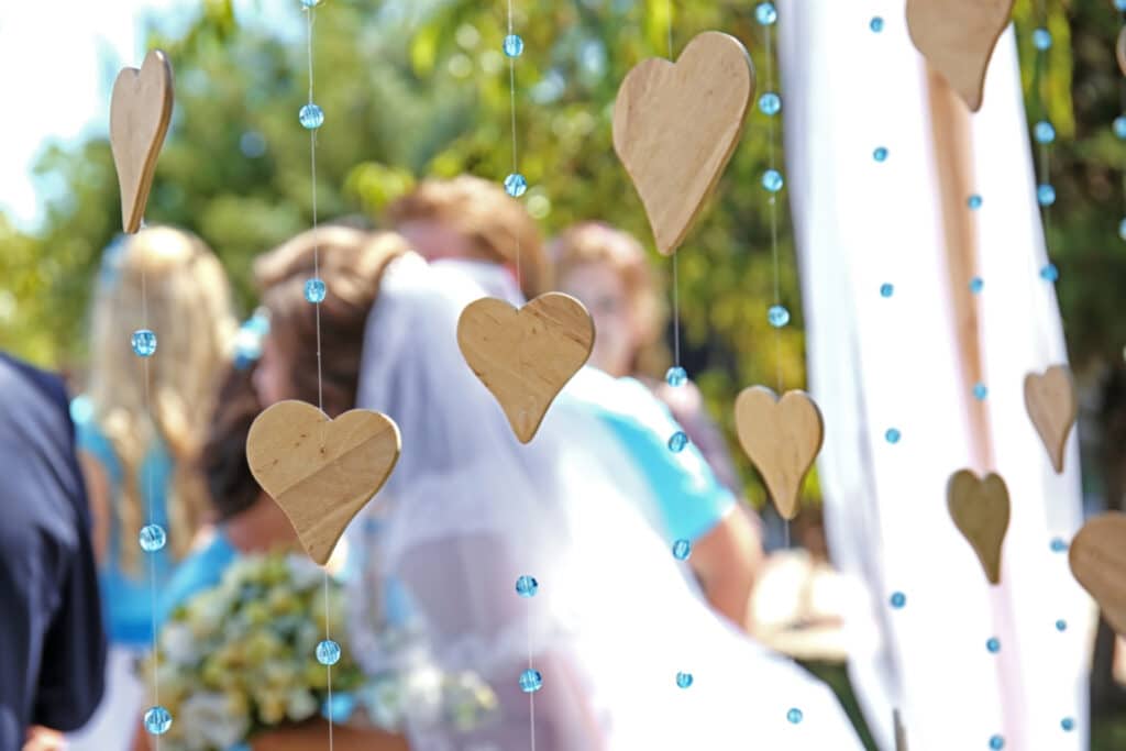 wedding decor with wooden hearts blurred newlyweds background